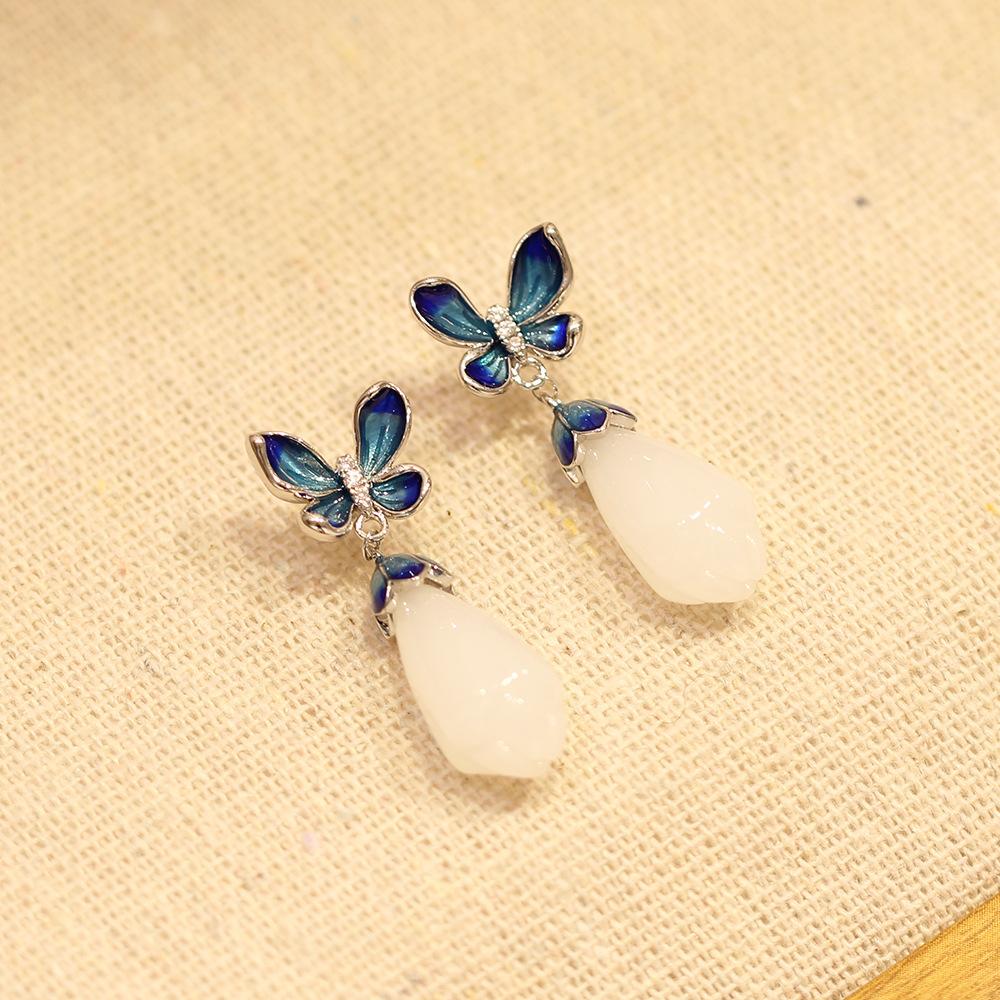 Elegant and elegant blue dripping butterfly stud earrings with simple temperament white magnolia flower imitation jade earrings silver needle women s