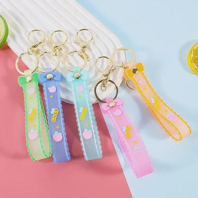 Schlüsselanhänger aus Silikon mit Glitzerschleife und Lederband – Geschenkaccessoire im Cartoon-Stil
