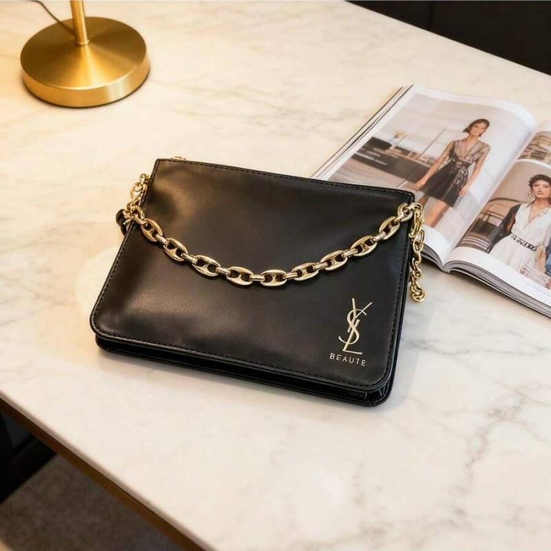 YSL black makeup crossbody bag with chain detailing, portable design, and large capacity, suitable for everyday use and travel.