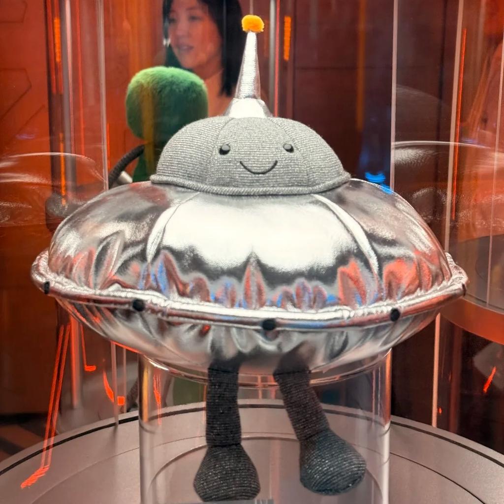 Peluche Espace Mignonne Alien Vert Souriant Soucoupe Volante Argentée Poupées Extraterrestres Douces Remplies Cadeau Adorable pour Fans de Science-Fiction Décoration de Maison