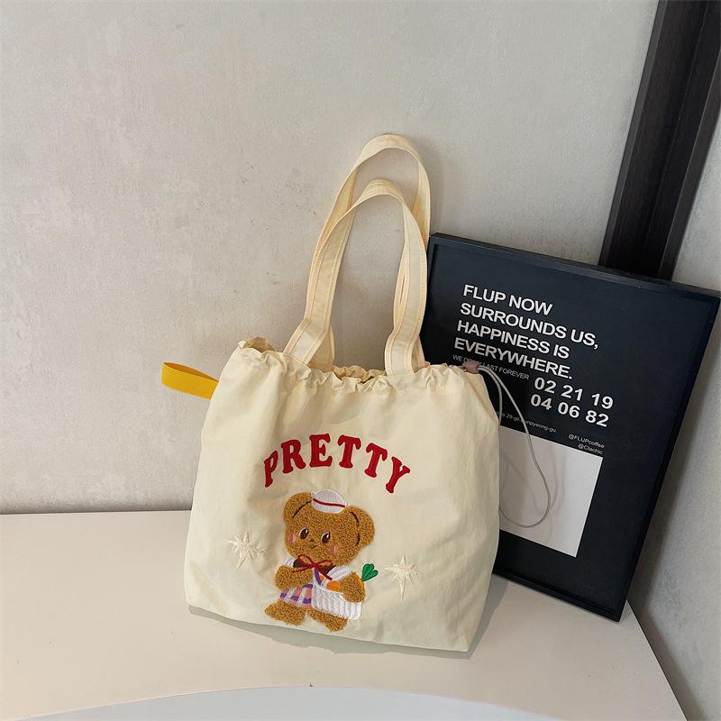

Large capacity tote bag women s 2025 new work commuter college student class shoulder bag cute cartoon bag