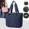 Women's portable folding storage bag with multiple compartments and adjustable shoulder strap for large capacity.
