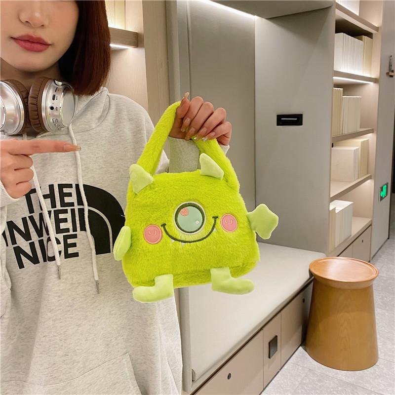 Autumn and Winter Fashion Plush Cartoon Portable Little Monster Three-eyed Flip Bag Large Capacity Double-sided Women's Bag Storage Bag