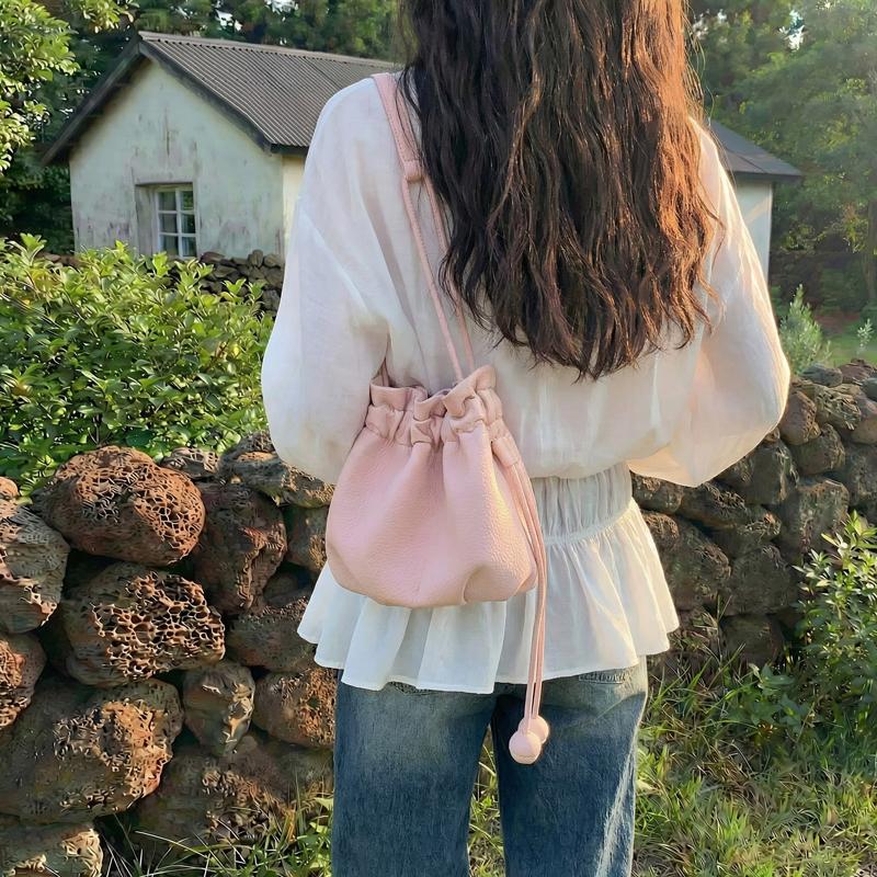 2026 New Drawstring Bucket Bag for Women Soft Leather Crossbody Bag with Ball Charm Mini Shoulder Handbag for Daily Shopping