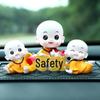 Creative Little Monk Maitreya Buddha Car Ornament: Cute, Shaking Head Resin Doll for Car Interior Decoration and Safety.