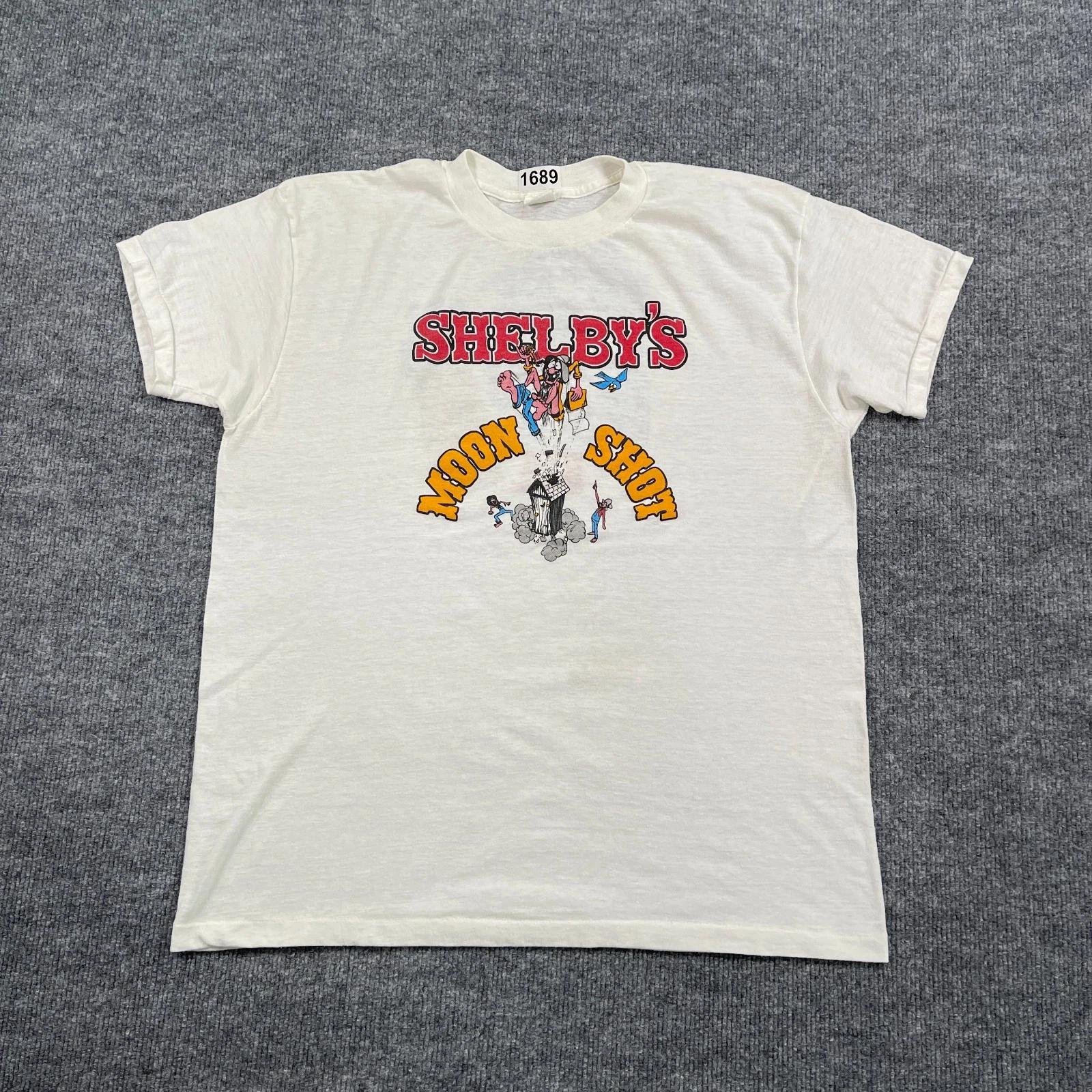 

Vintage 80 s Shelby s Moon-Shot Chili Kit Shirt Large 21x25 White Texas 2XL