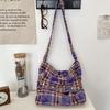 New tie-dye plaid one-shoulder messenger bag, flip zipper canvas bag, large-capacity commuter underarm bag.