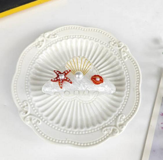 Elegancka spinka do włosów z cyrkoniami w kształcie rozgwiazdy i muszelkowa klamra do upięć