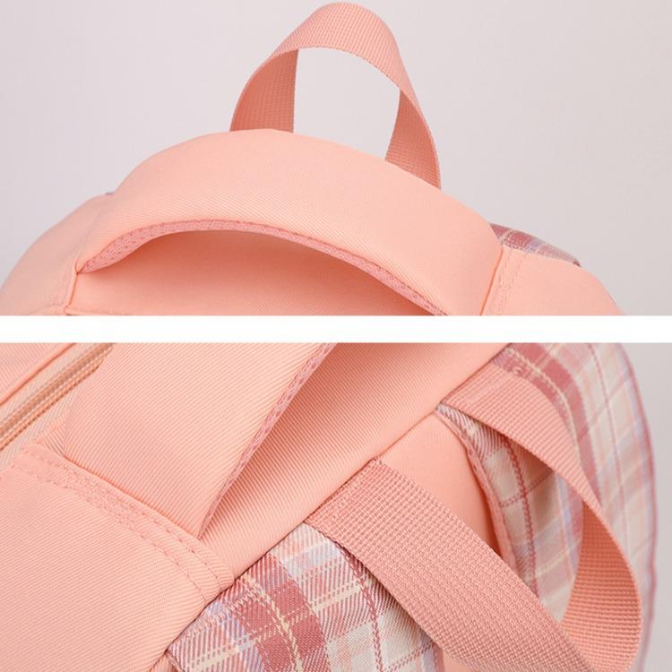 New schoolbag for primary school students, plaid load-reducing ridge backpack, anti-splashing water and wear-resistant canvas backpack, fashionable.