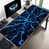 A Large Electronic Sports Gaming Mouse Pad Featuring a Black Stone Texture with Blue Glowing Cracks Designed for Easy Cleaning
