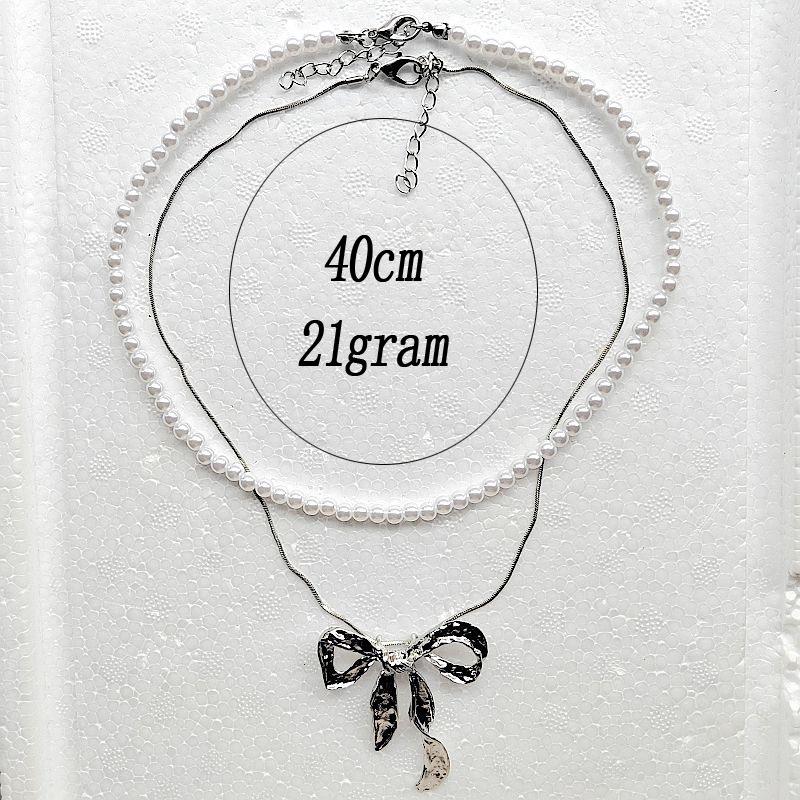 European & American Summer Fashion: Layered Alloy Bow Tie Necklace with Faux Pearl.