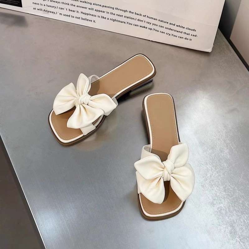 Low-heeled bow one-word drag women's summer wear flat-bottomed square-head slippers 2025 new seaside beach shoes