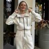Tuta intera da donna casual europea e americana con cappuccio in vita a tinta unita a maniche lunghe con cerniera sportiva intera
