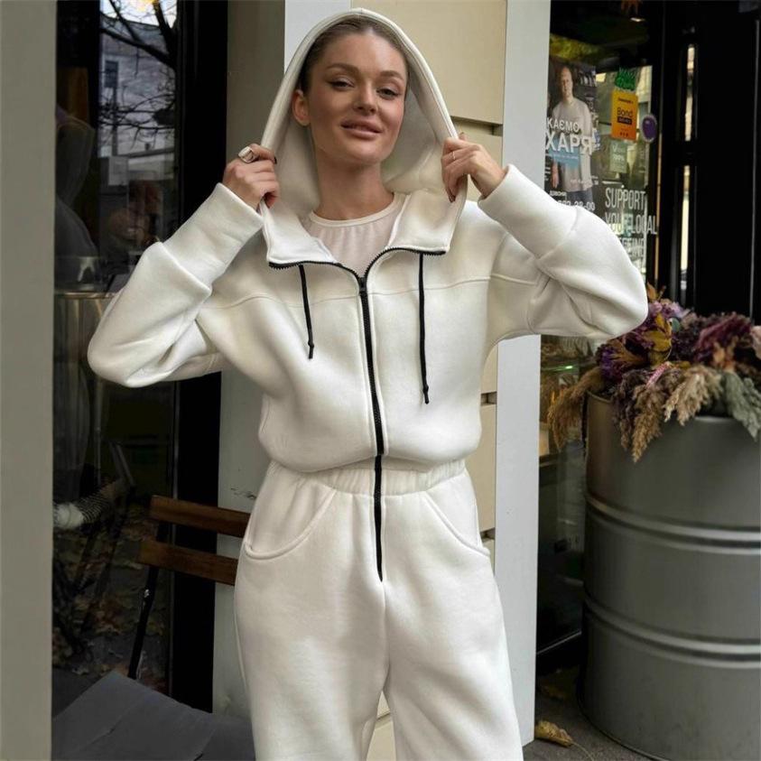 Tuta intera da donna casual europea e americana con cappuccio in vita a tinta unita a maniche lunghe con cerniera sportiva intera