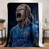 The pattern depicts a fierce animated figure in a blue soccer jersey. for all seasons blanket lunch break throw gift