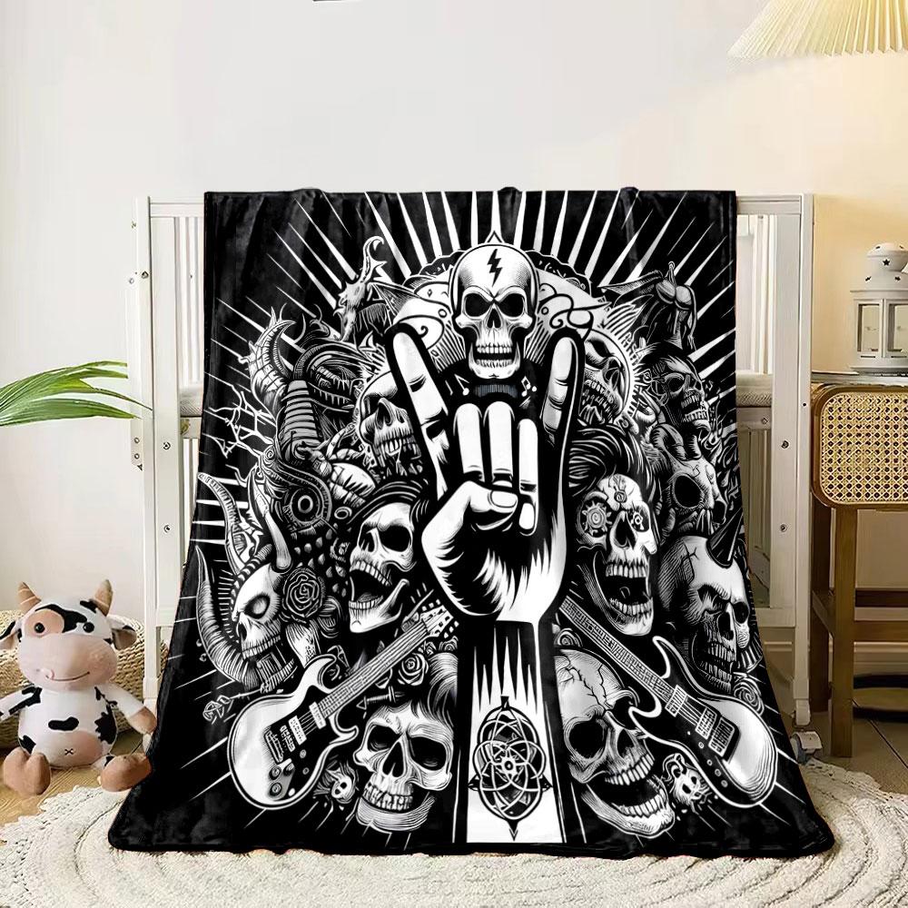 A skull-heavy design with a "rock on" hand gesture, guitars, and dark motifs. for all seasons blanket lunch break throw gift