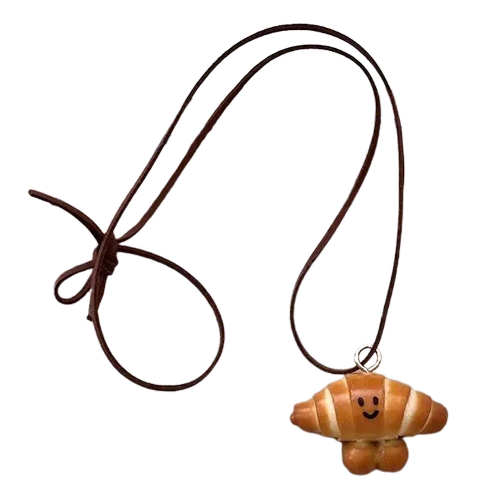 

Многофункциональное художественное ожерелье с подвеской в виде хлеба, украшенное миниатюрами в виде венка и улыбающегося кренделя, модный аксессуар B