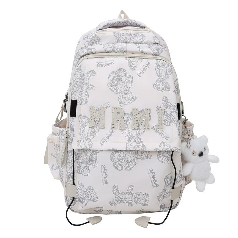 The new bear graffiti backpack has a large capacity of foreign style tide and a couple of middle and high school students have a class backpack tide.