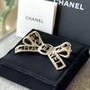 Used Brooch / Coco Mark Rhinestone Ribbon Motif