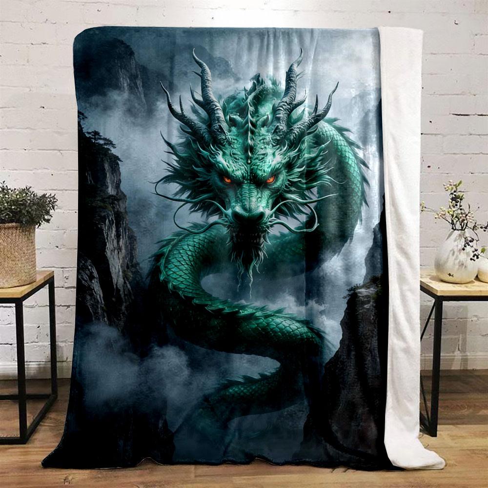 A green, serpentine dragon with glowing eyes emerges amidst misty cliffs. for all seasons blanket lunch break throw gift
