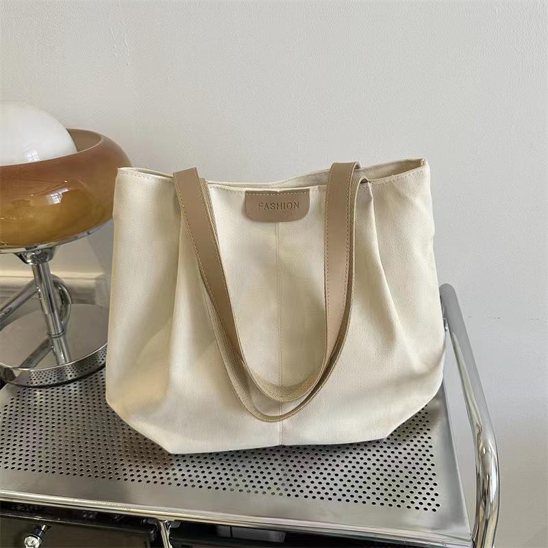Women's new one-shoulder handbag, separated tote bag, large-capacity hand-carried canvas bag.