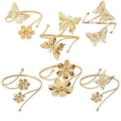 Metallarmband med fjäril och blomma, öppet och med infattade diamanter