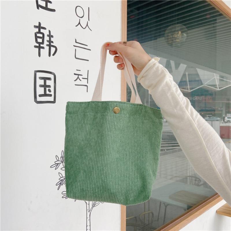[Spot] Literary and artistic corduroy bag portable casual women's small hand bag retro cloth bag bento bag