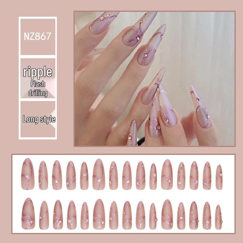 

Розовые матовые ногти миндалевидной формы со стразами и неровными волнистыми линиями