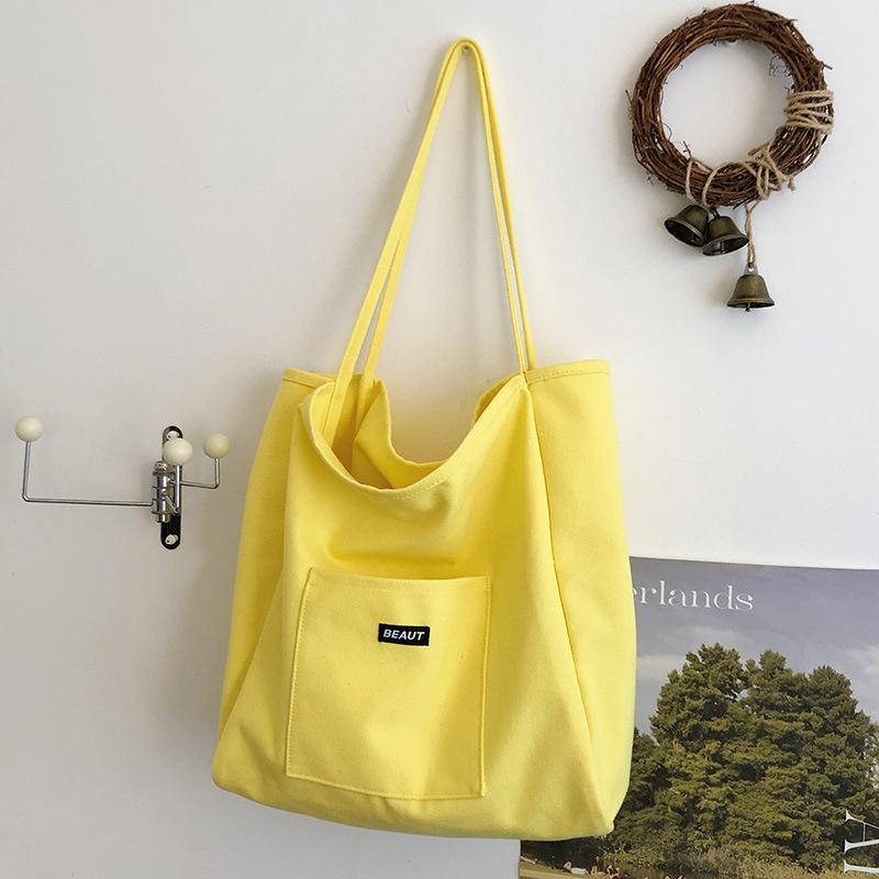 Bolsa de lona com letra de cor sólida 2026 nova ins grande capacidade simples moderna bolsa de ombro versão coreana bolsa tote artística