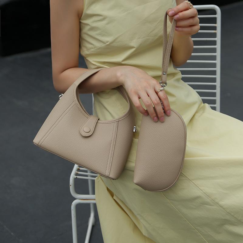 Leather women's bag semi-round moon bag niche design 2025 new cowhide shoulder crossbody armpit bag portable