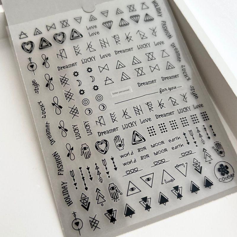 

Boys Silver Nail Sticker with Geometric Triangle Symbol A black geometric triangle symbol