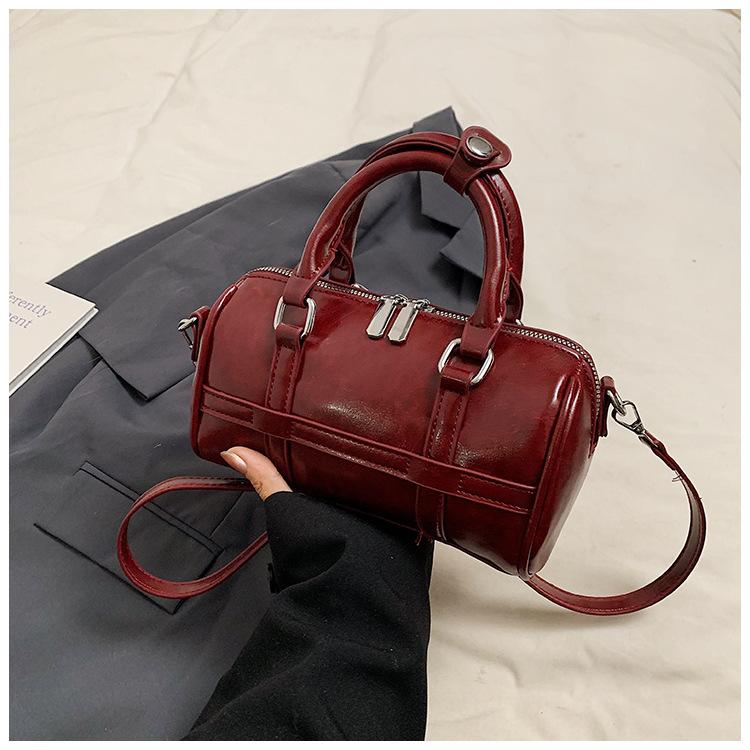 Fashion hand-held bowling bag women's 2025 autumn new simple niche trend commuter PU shoulder messenger women's bag