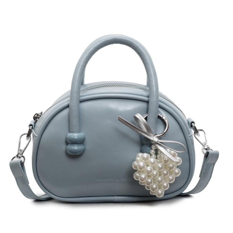 Korean version of the hot-selling cream style portable bowling bag, girls' fashion and advanced sense, foreign style versatile simple messenger bag