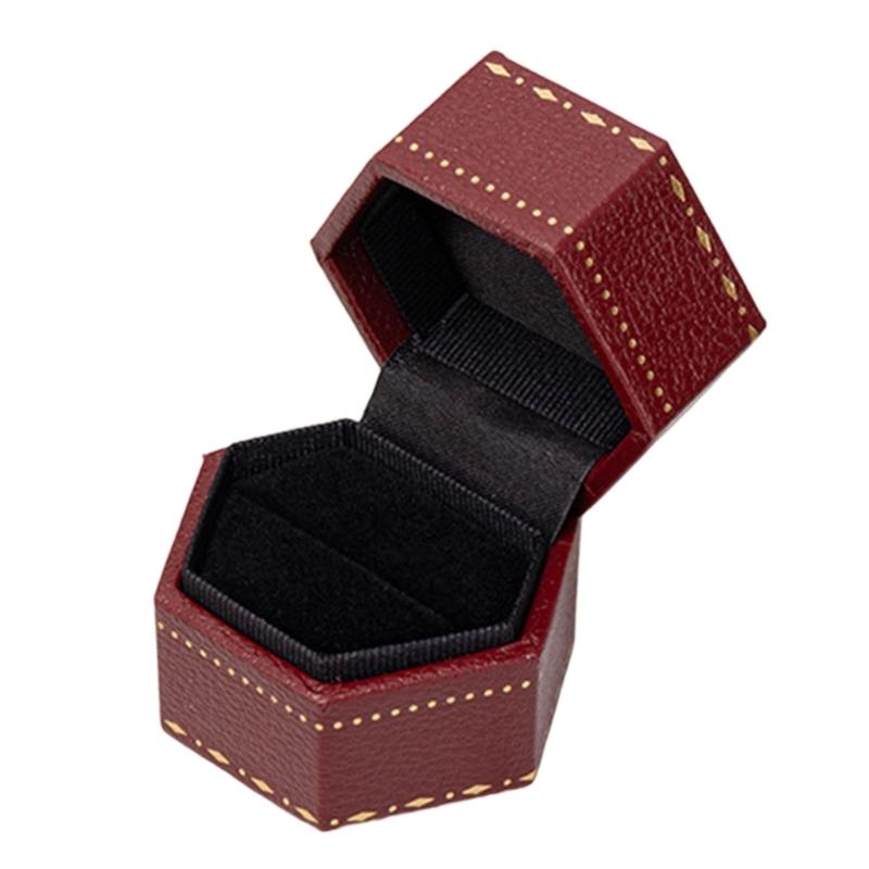 Hexagonal Ring Presentation Box with Black Interior, Gold-Tone Border Pattern, and Attached Lid for Retail Display