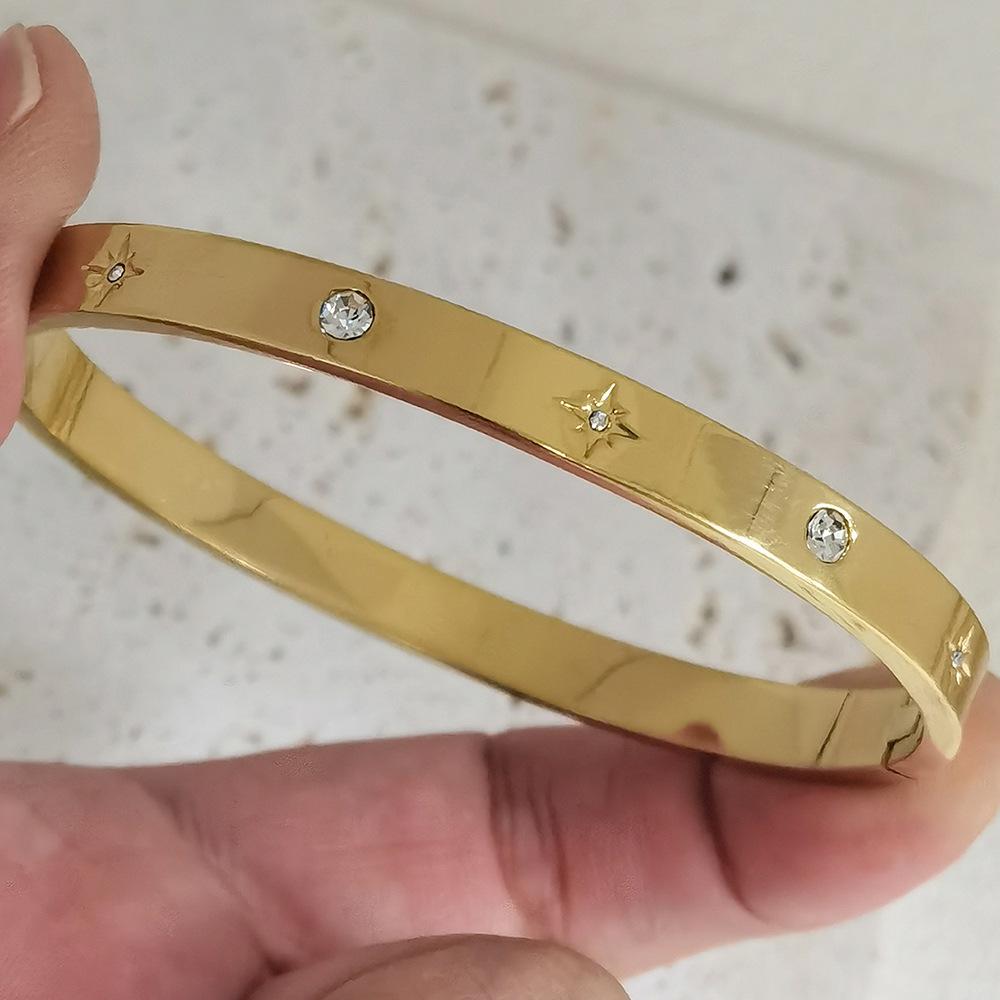 Gold Heart-Shaped Stainless Steel Bracelet with Embroidered Bow and Tassel Woven Cord.