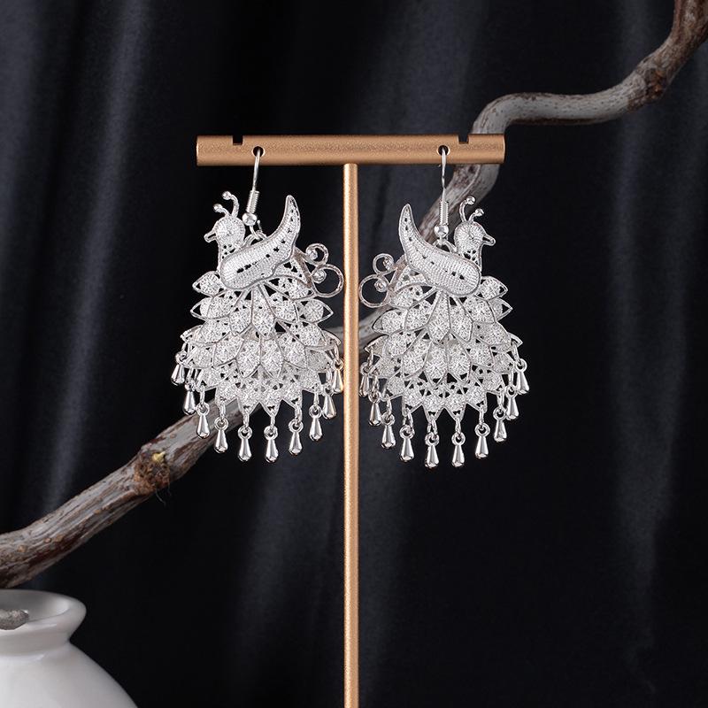 Bohemian Ethnic Miao Silver Tassel Earrings with Butterfly, Peacock, and Flower Design for Women – Long Dangle Jewelry for Travel Photos.