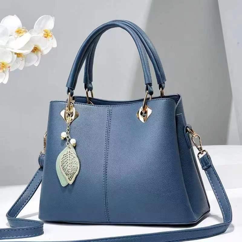 Versatile Medium Sized Bucket Handbag For Women With Trendy Chain And Lock Closure синий
