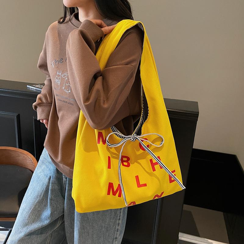 Large capacity double-sided canvas bag women's 2025 new color letter bow shoulder bag fashion student schoolbag