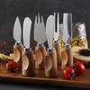 Stainless Steel Cheese Knife Set with Rubber Wood Handles: Knife, Fork, Spoon, Butter Knife, and Spatula.