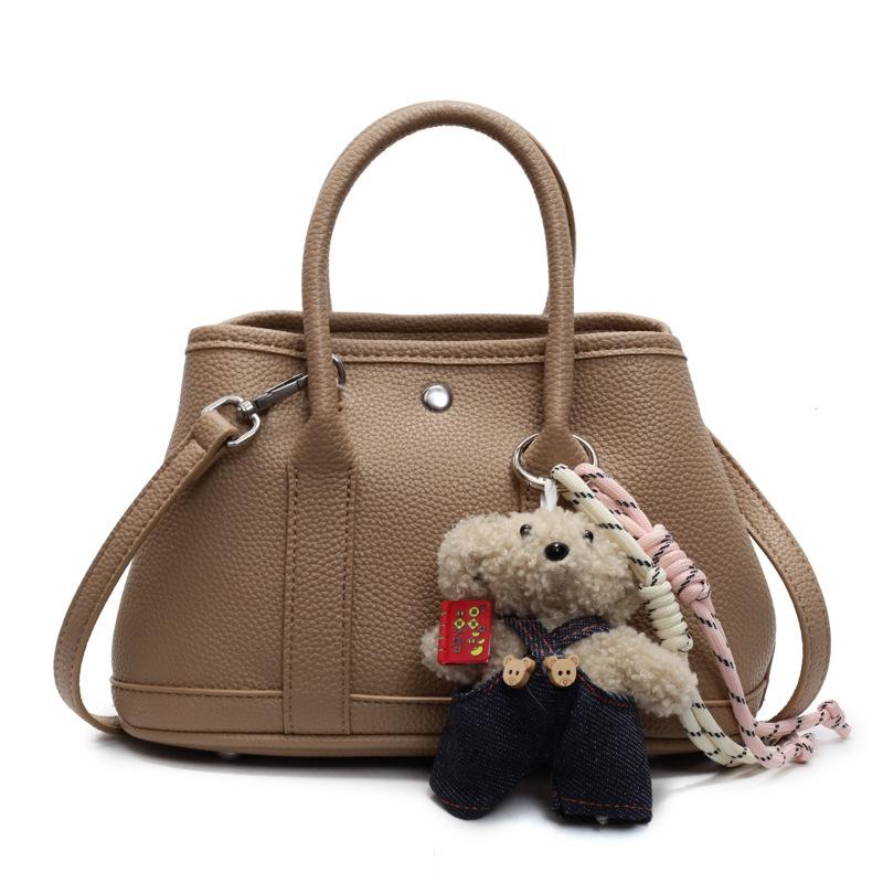 2025 New Niche Simple Leisure Commuter Portable Bucket Bag Versatile Solid Color Child and Mother Bag Messenger Bag Bag