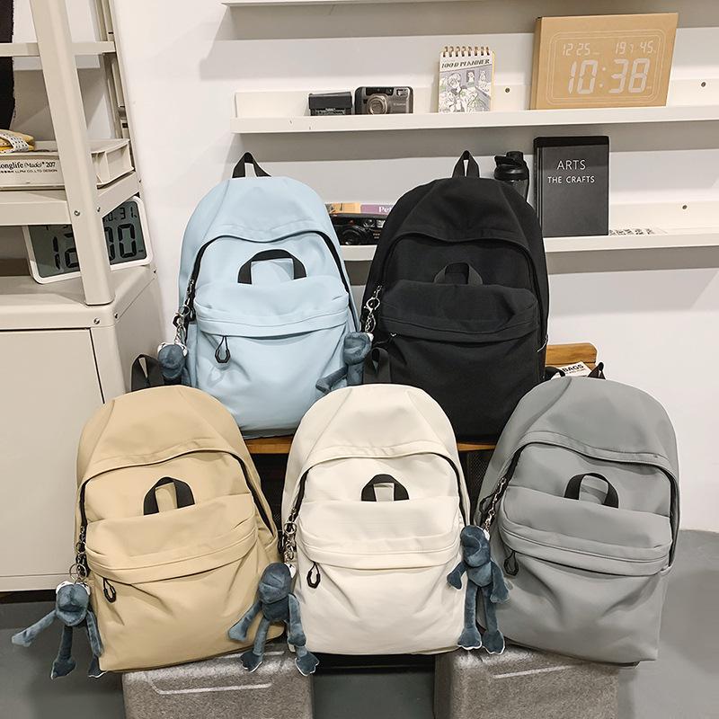 Casual large-capacity backpack fashionable outdoor lightweight junior high school students solid color simple schoolbag Korean version travel backpack