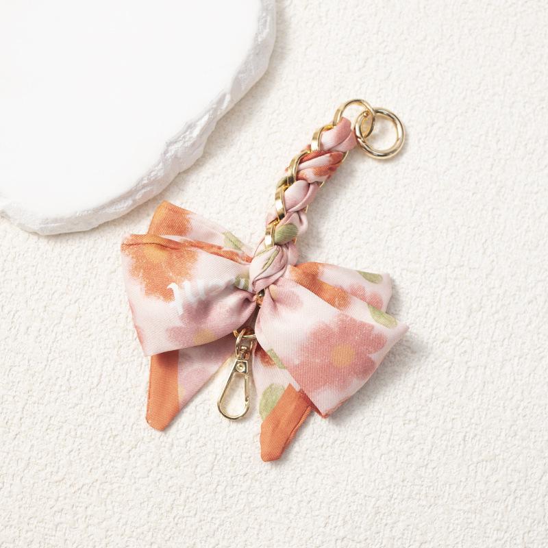 Elegant Hand-Woven Scarf Chain with Bow Decoration Pendant for Bag Strap Modification.
