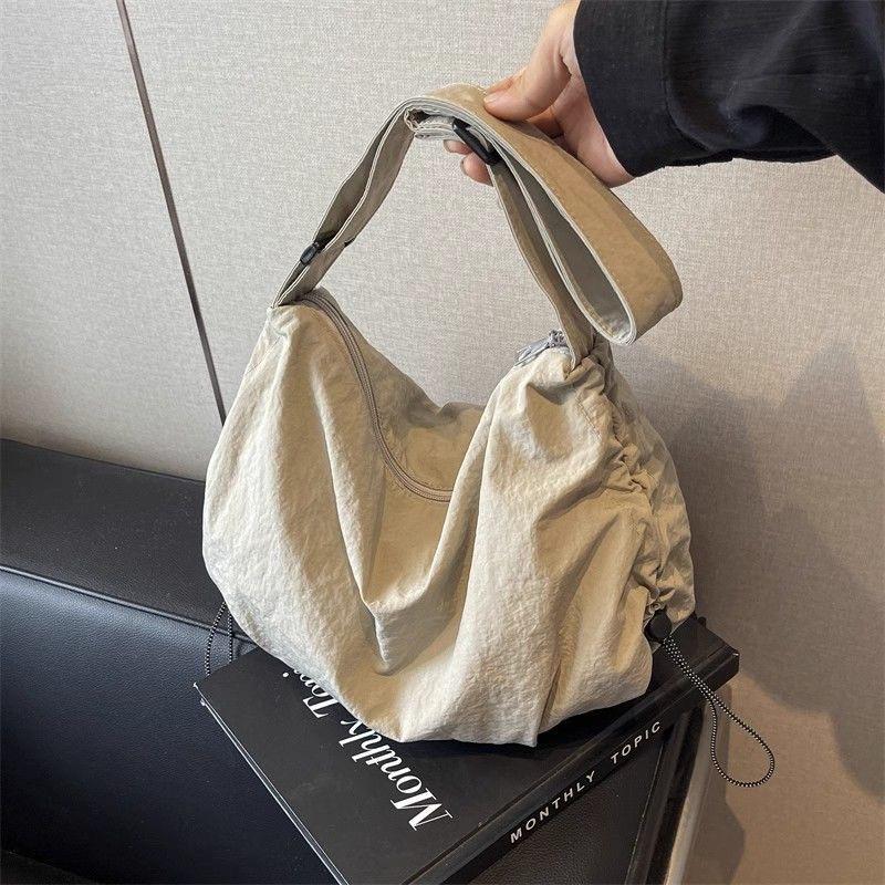 Japanese-Style Waterproof Nylon Dumpling Crossbody Bag: Sporty, Large-Capacity Tote for Men & Women, Ideal for Cycling & Relaxed Shoulder Wear.