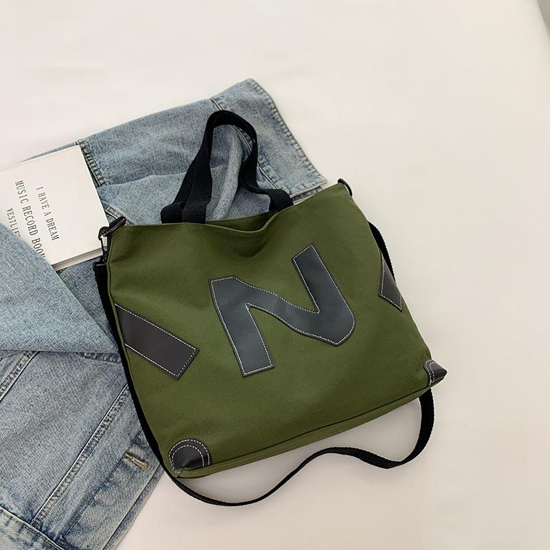 

2025 early autumn new casual large-capacity ins student shoulder tote bag double-sided embossed letter canvas bag women зелений