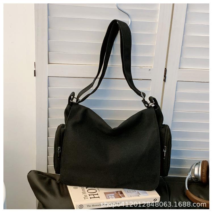 

Canvas large-capacity messenger bag female student business class portable shoulder canvas bag new casual commuter bag чёрный