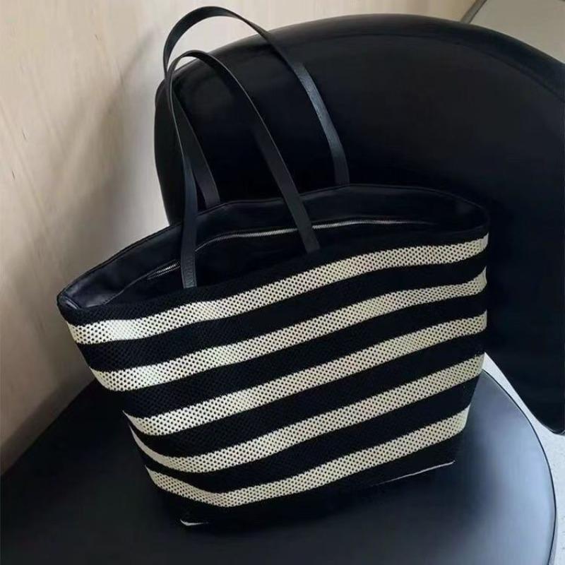 

Korean version of large-capacity tote bag cowhide splicing contrasting color bucket bag summer new hollow woven bag lazy wind bag