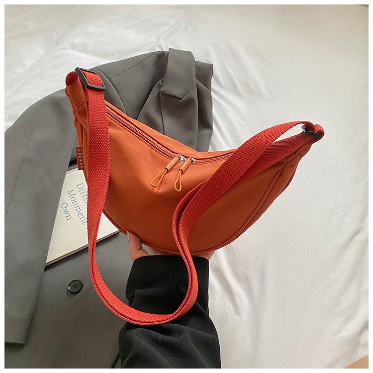 

Small bag bag women s 2025 new Japanese and Korean casual light dumpling bag niche design crossbody bag nylon cloth mobile phone bag помаранчевий