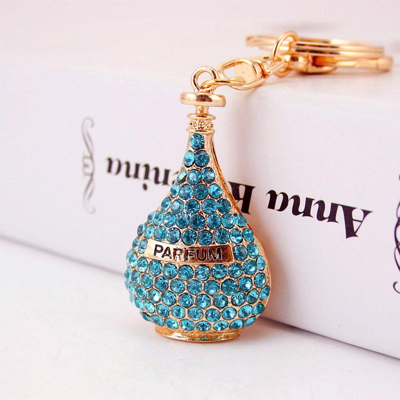 Elegant Diamond-Studded Four-Leaf Clover Keychain: Perfume Bottle Bag Charm for Women
