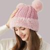 Niedliche Damen Wintermütze mit Bommel aus Wolle, Plüschrand und Ohrenschutz