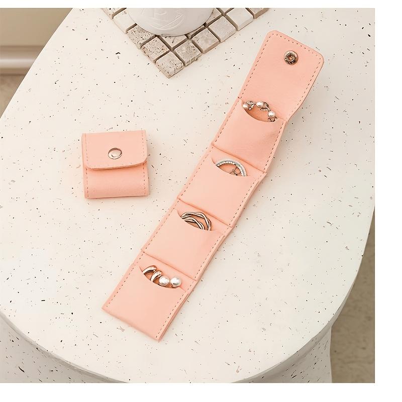 

Foldable Genuine Leather Travel Jewelry Roll—A portable jewelry organizer with multiple compartments and a snap closure. розовый